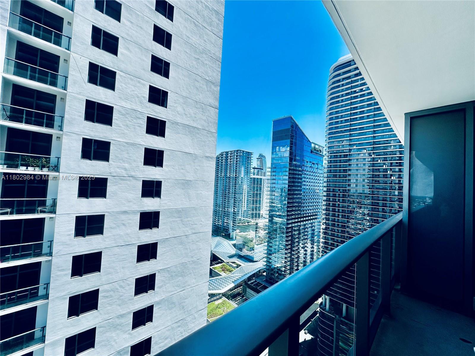 55 Southwest 9th Street, Unit 3409 Miami, FL 33130 - Photo 7 of 28 a view of a balcony with a large window and wooden floor