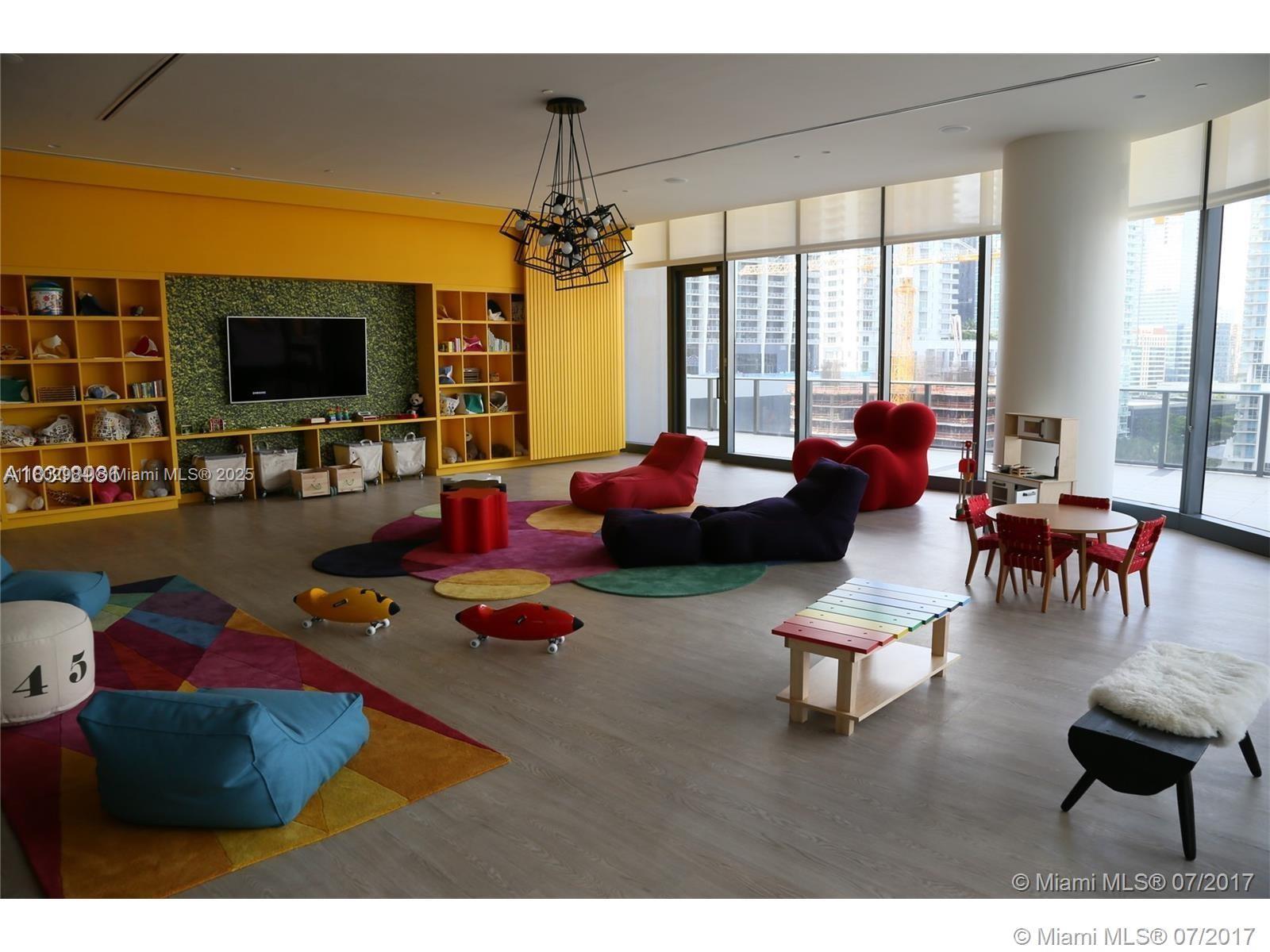 55 Southwest 9th Street, Unit 3409 Miami, FL 33130 - Photo 9 of 28 a living room with furniture and flat screen tv