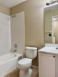 a white toilet sitting next to a bath tub