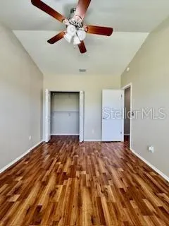a bedroom with a bed and a ceiling fan