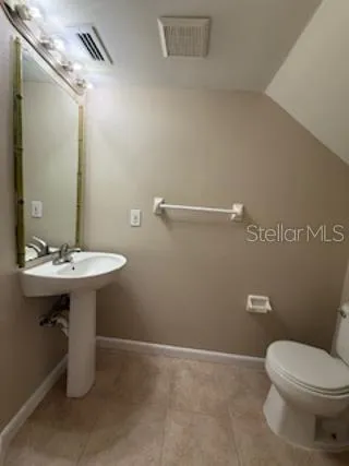 a bathroom with a sink a toilet and mirror