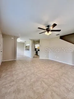 a view of a livingroom with a furniture and chandelier fan