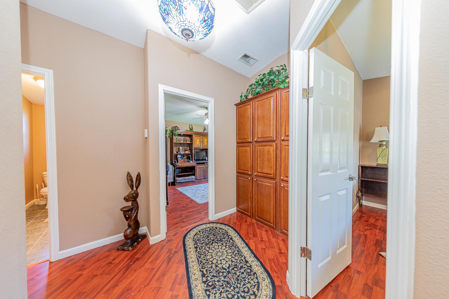 3335 Wildcat Road Mariposa, CA 95338 - Photo 15 of 48 a view of a hallway with wooden floor and a bathroom