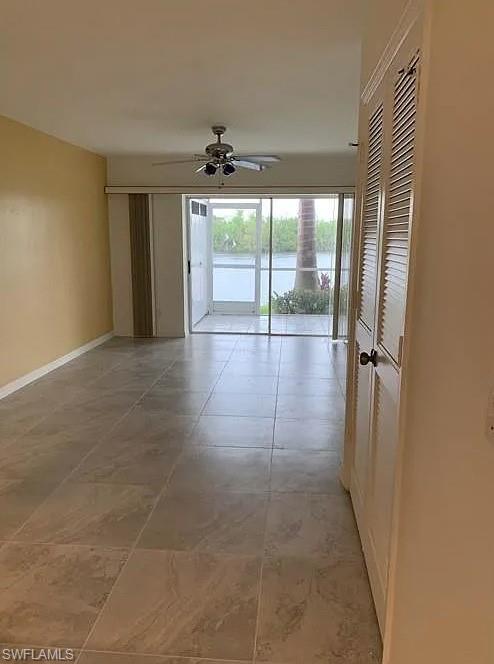 1305 Mainsail Drive, Unit 1002 Naples, FL 34114 - Photo 3 of 10 a view of a livingroom with a ceiling fan and window