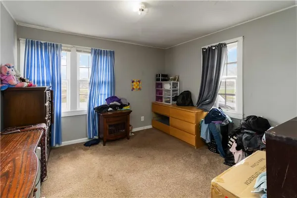 a bedroom with furniture and a flat screen tv