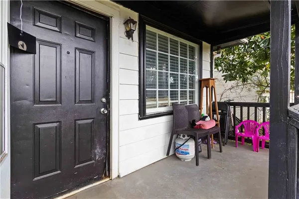 a view of a porch with chairs and a yard