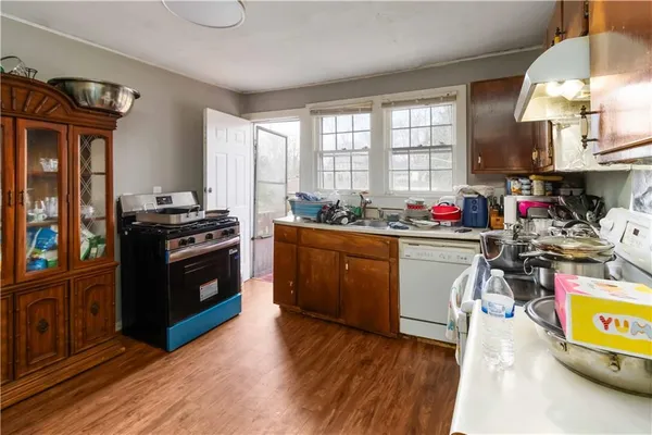 a kitchen with stove a sink and appliances