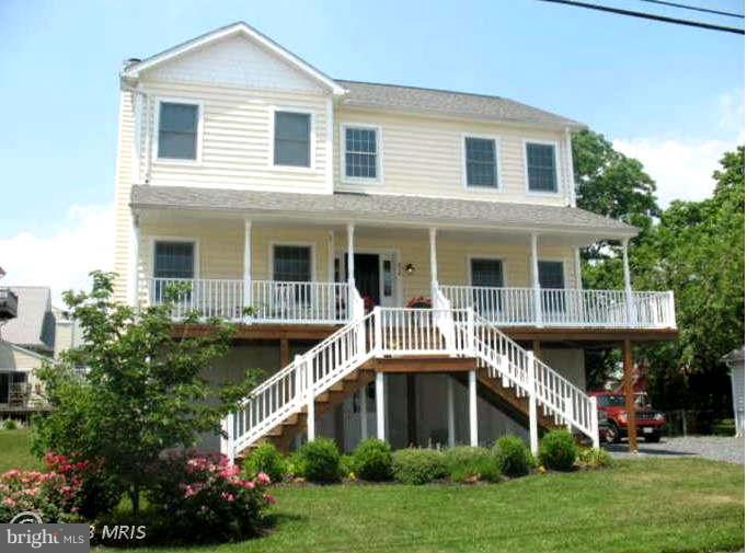 9118 Cuckold Point Road Baltimore, MD 21219 - Photo 22 of 27 a front view of a house with a yard