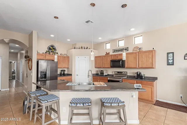a kitchen with stainless steel appliances granite countertop a sink and cabinets