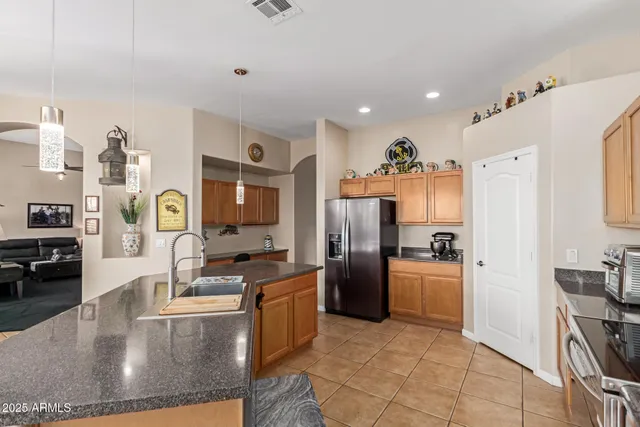 a large kitchen with stainless steel appliances a lot of counter space and a window