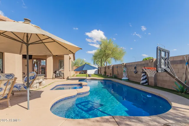 a view of a swimming pool with a lounge chairs