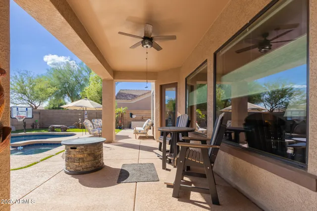 a view of a patio with a table and chairs