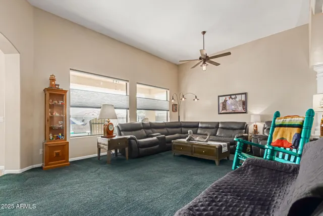 a living room with furniture and a chandelier