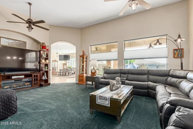 a kitchen with stainless steel appliances granite countertop a stove top oven a sink dishwasher a dining table and chairs with wooden floor