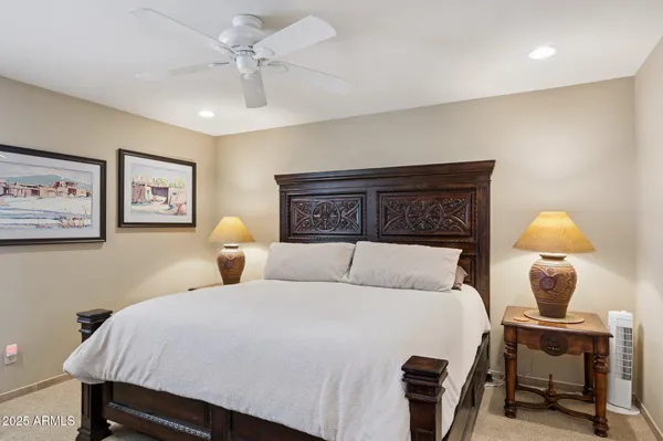 a bedroom with a bed and lamp chandelier