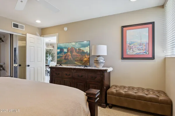 a bedroom with a bed and a dresser