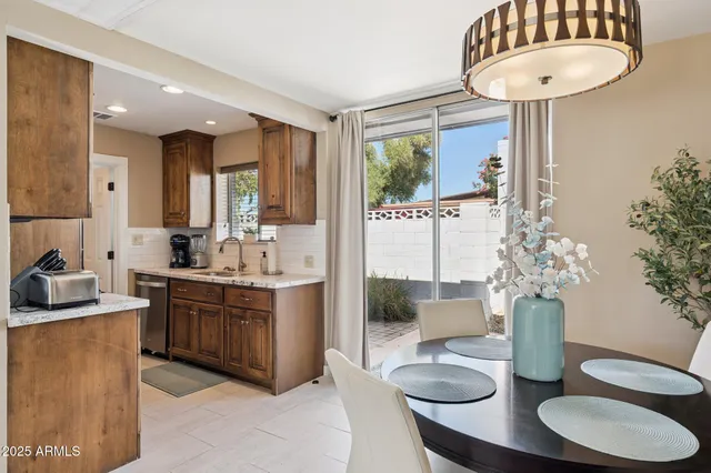 a kitchen with stainless steel appliances granite countertop a sink and a refrigerator