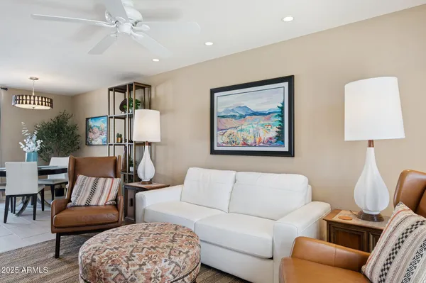 a living room with furniture a rug and a chandelier