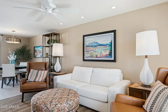 a living room with furniture a rug and a chandelier