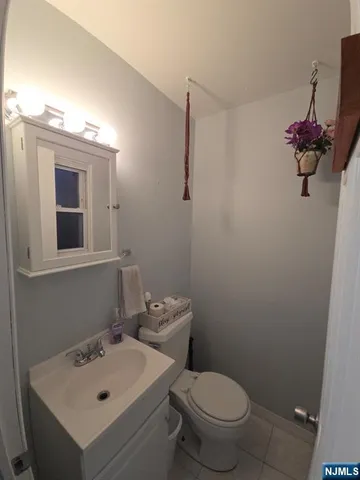 a bathroom with a sink mirror and toilet