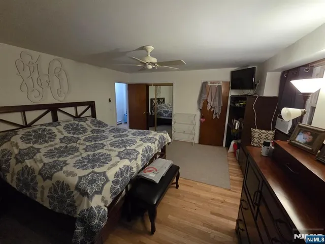 a bed sitting in a room next to a window