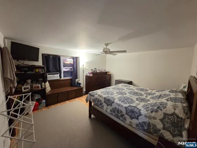 a bedroom with a bed and dresser