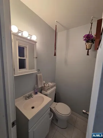 a bathroom with a sink toilet and mirror