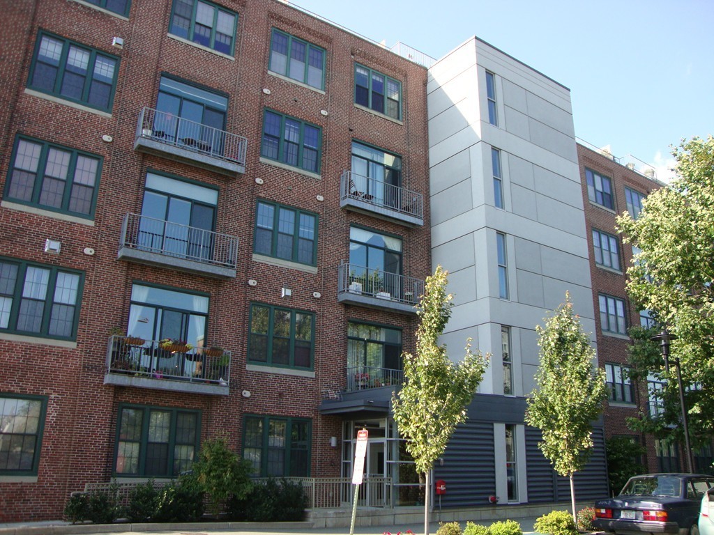 210 Broadway, Unit 104 Everett, MA 02149 - Photo 11 of 13 a front view of a multi story building with a yard