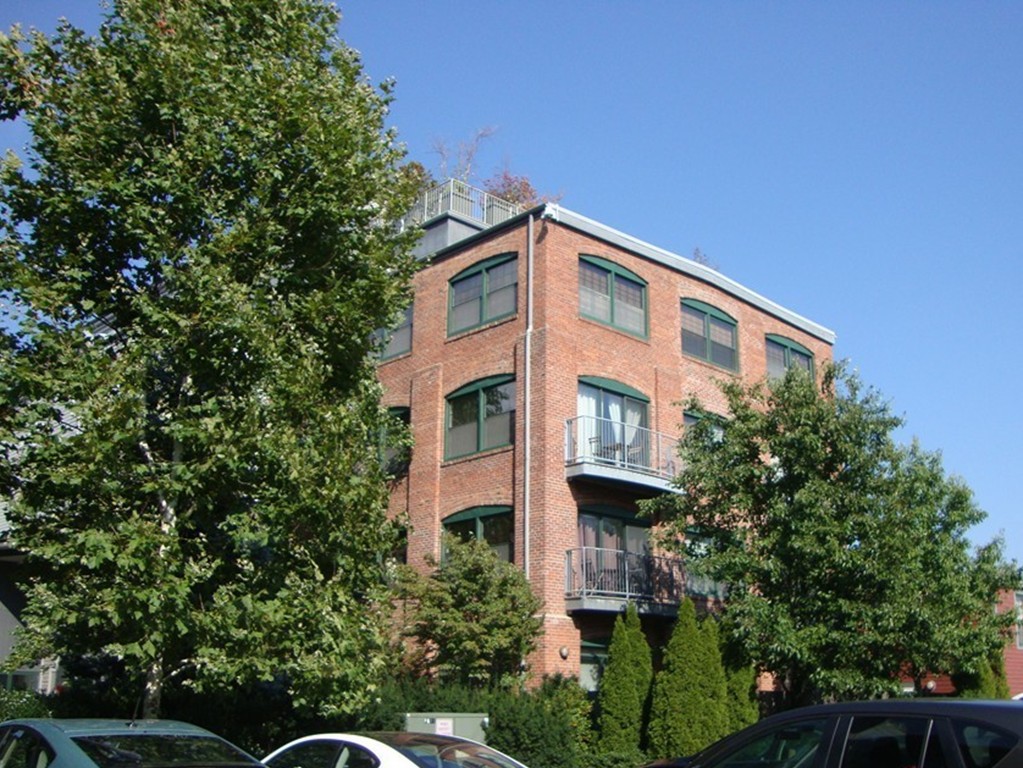 210 Broadway, Unit 104 Everett, MA 02149 - Photo 12 of 13 a front view of a house with a yard