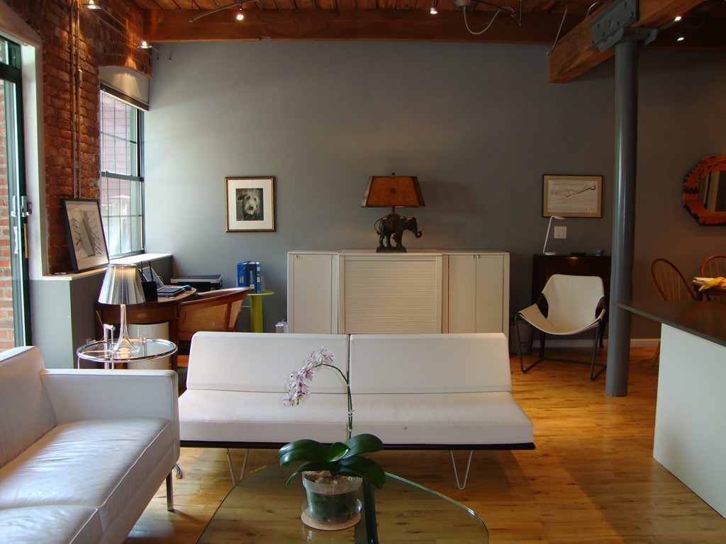 210 Broadway, Unit 104 Everett, MA 02149 - Photo 2 of 13 a living room with furniture and a large window