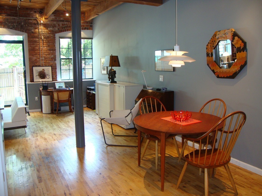 210 Broadway, Unit 104 Everett, MA 02149 - Photo 4 of 13 a view of a dining room with furniture and chandelier