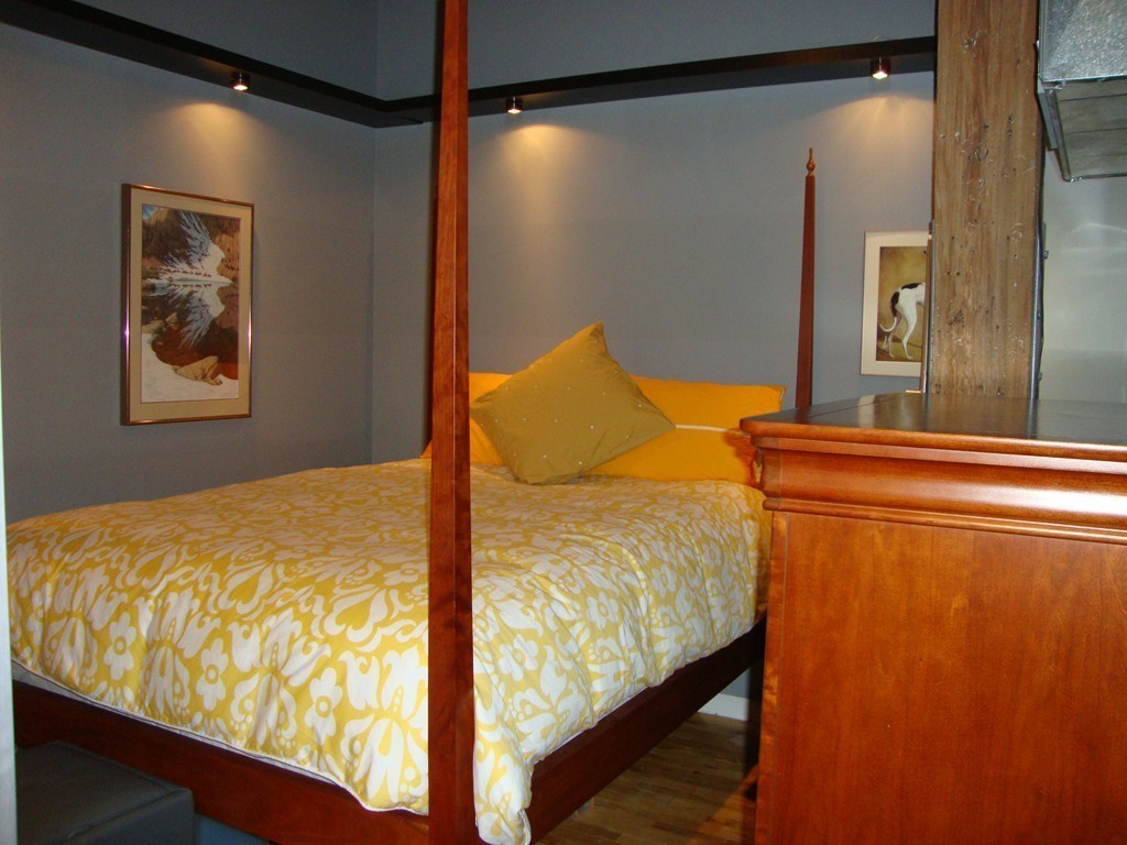 210 Broadway, Unit 104 Everett, MA 02149 - Photo 6 of 13 a bed sitting in a bedroom next to a window