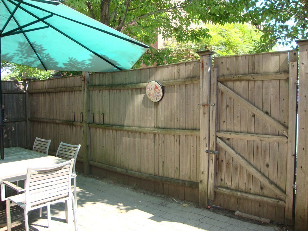 210 Broadway, Unit 104 Everett, MA 02149 - Photo 9 of 13 a backyard of a house with table and chairs