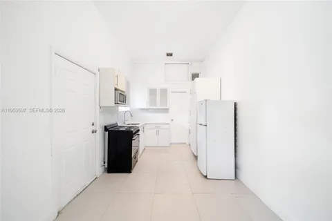 a kitchen with cabinets appliances and a window