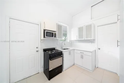 a white refrigerator freezer sitting inside of a kitchen