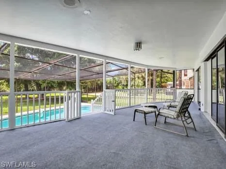 a view of a livingroom with furniture and floor to ceiling window