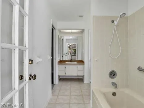 a bathroom with a tub a sink and a mirror