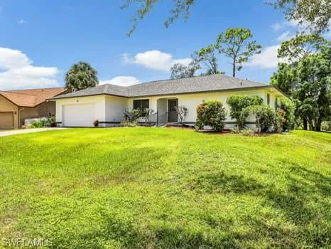 a view of a house with a yard and potted plants