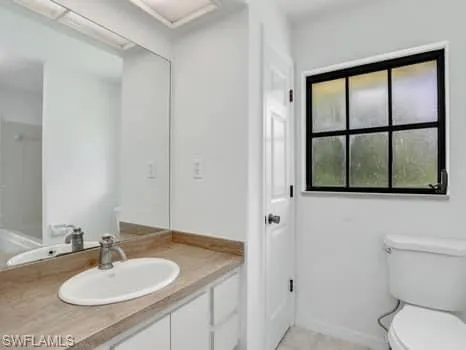 a bathroom with a sink toilet a mirror and shower