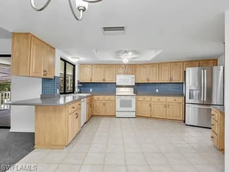 a large kitchen with cabinets and stainless steel appliances