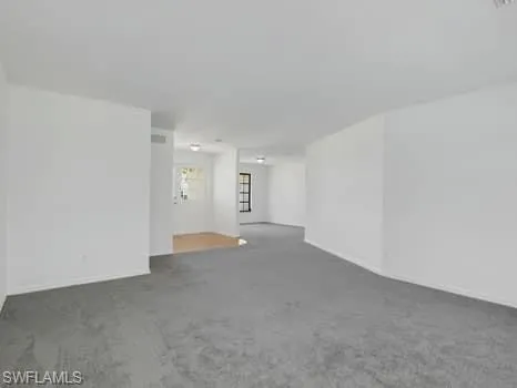 a view of a kitchen with white cabinets