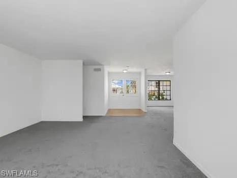 a view of a big room with closet and windows