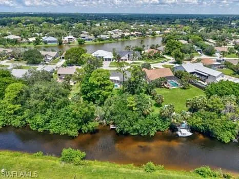 an aerial view of residential houses with outdoor space and lake view