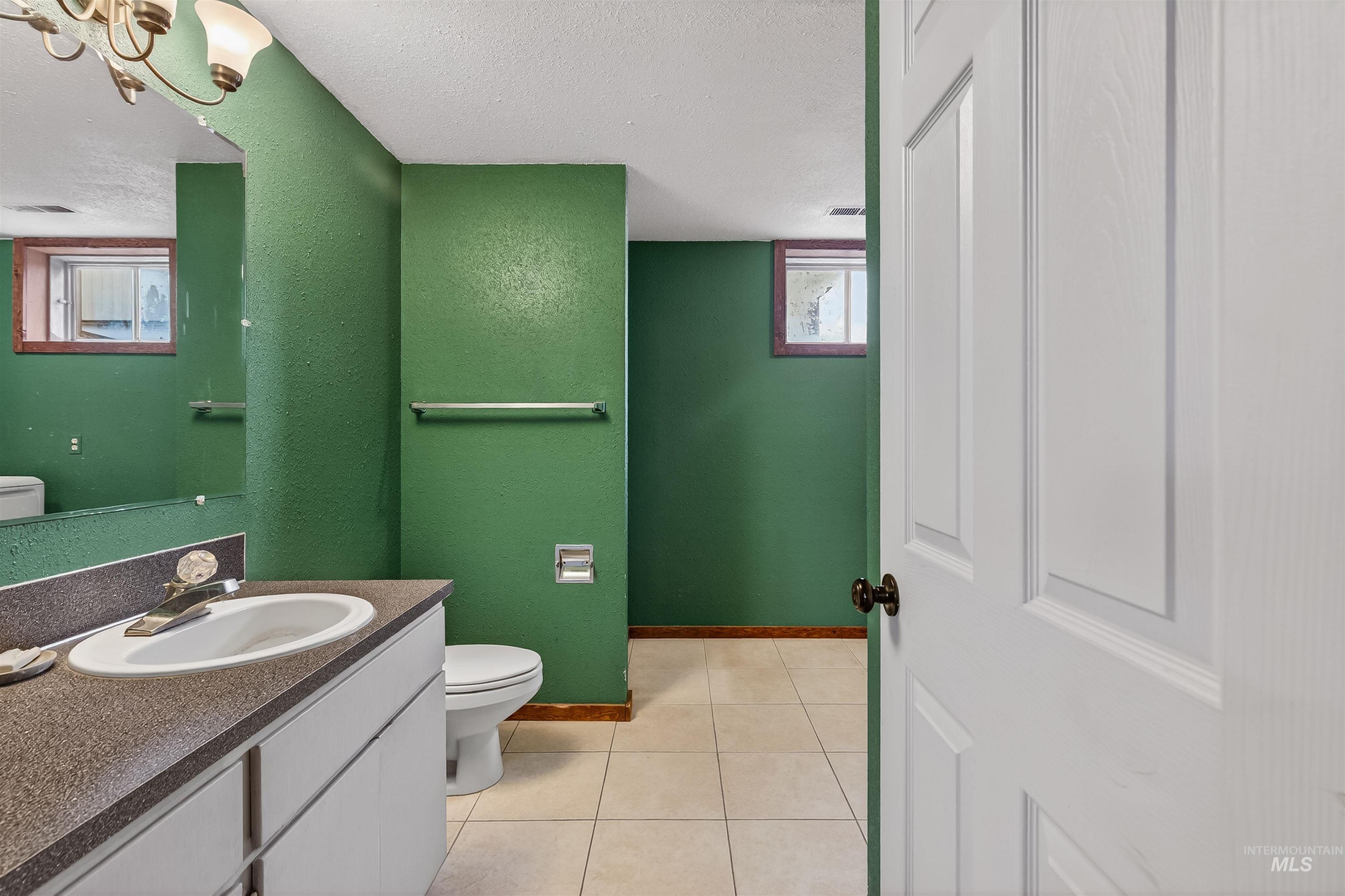 3725 11th Street Lewiston, ID 83501 - Photo 30 of 46 Bathroom with vanity, a textured ceiling, and light tile patterned flooring