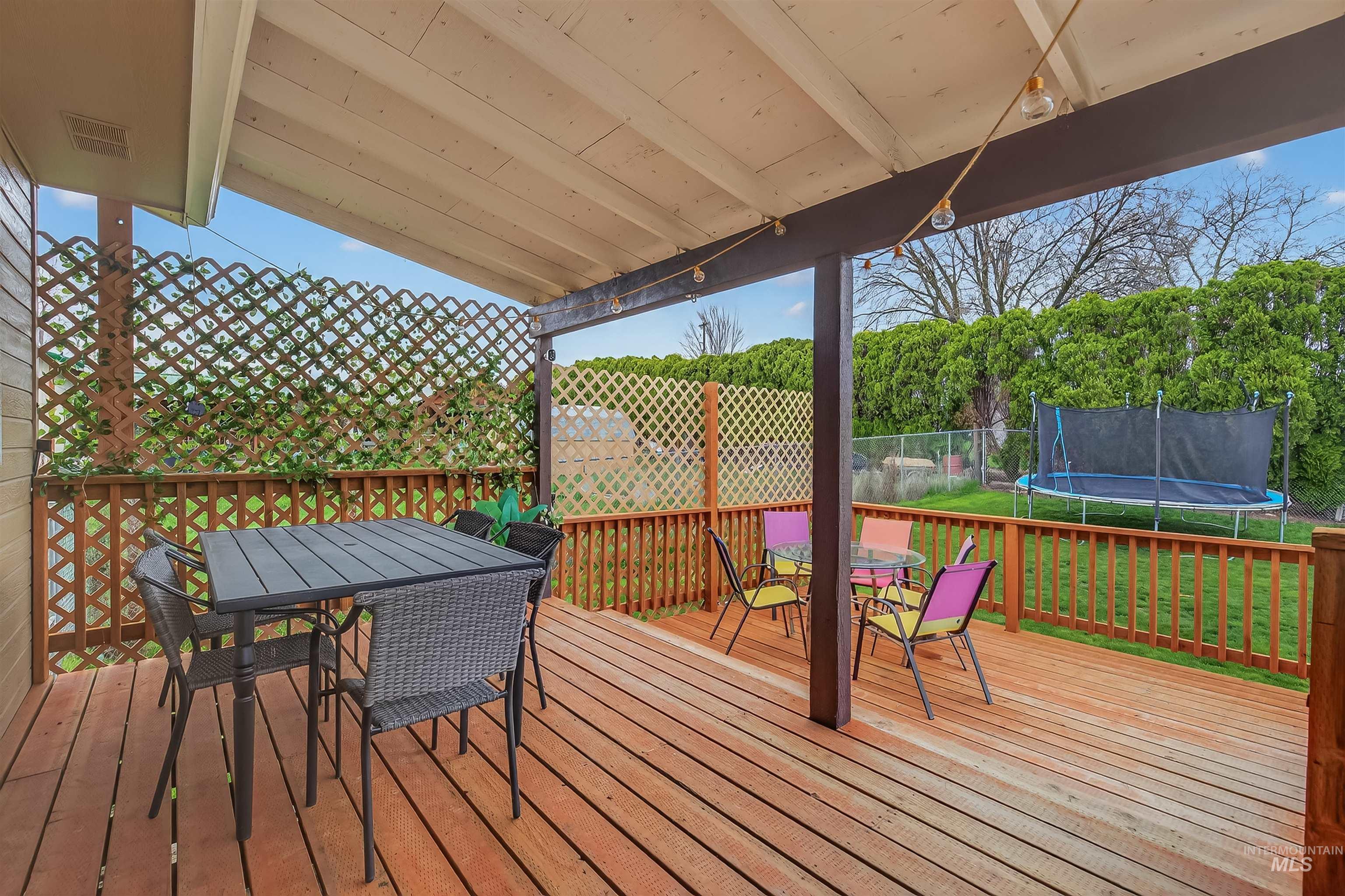 3725 11th Street Lewiston, ID 83501 - Photo 36 of 46 Deck featuring outdoor dining space, a trampoline, and a fenced backyard