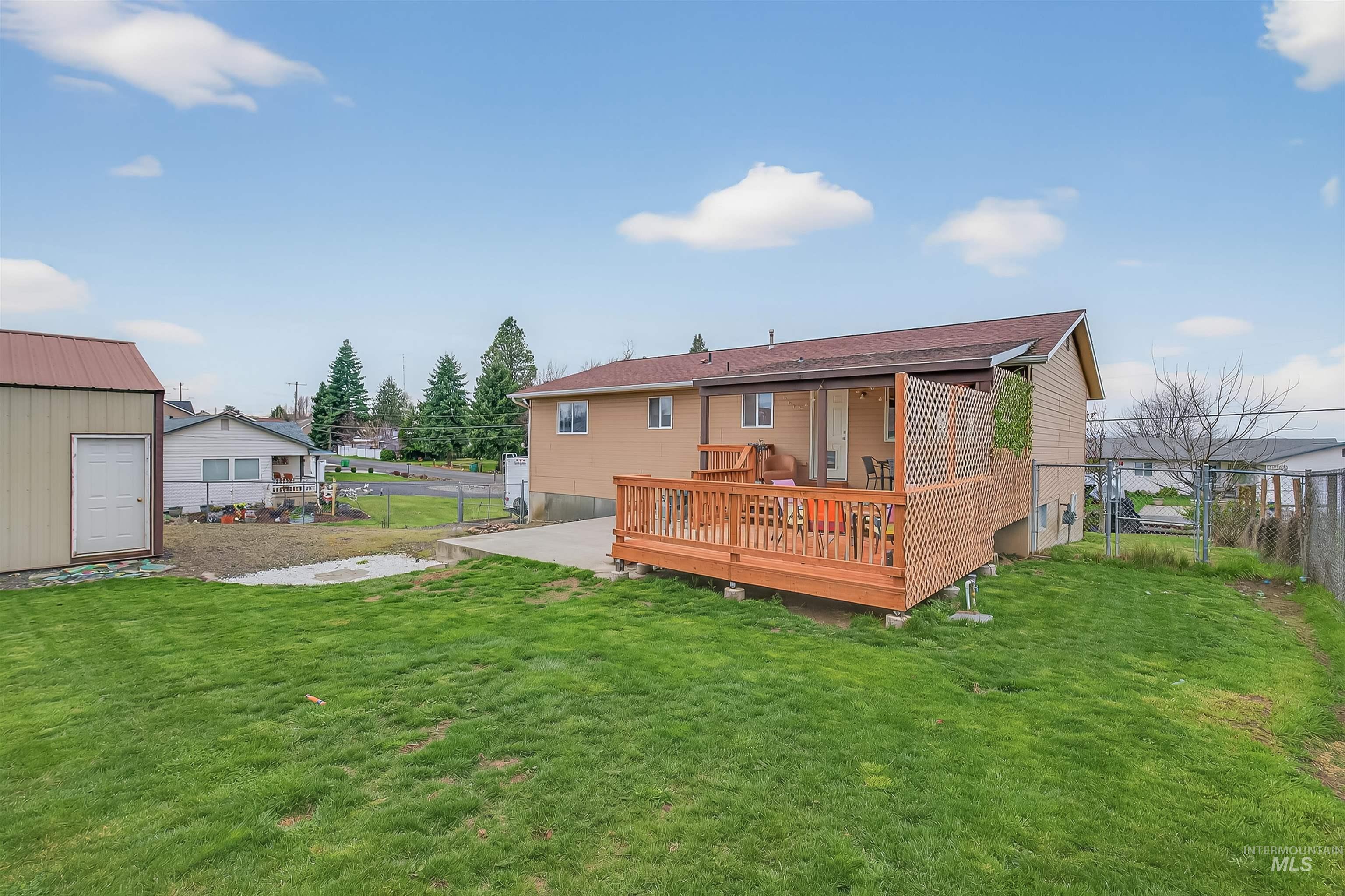 3725 11th Street Lewiston, ID 83501 - Photo 42 of 46 Back of house featuring a fenced backyard, a deck, and a gate