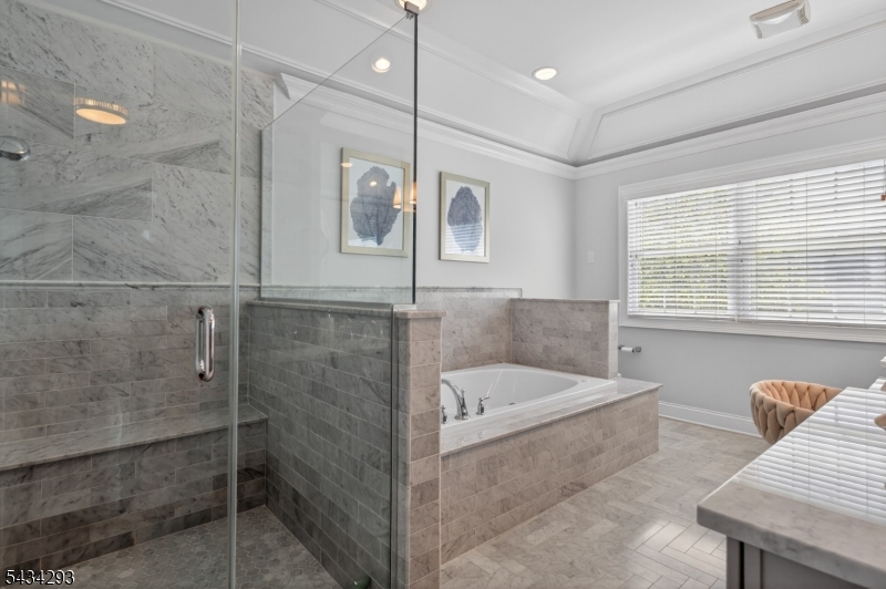 921 Harding Street Westfield, NJ 07090 - Photo 30 of 50 a bathroom with a tub a sink and large window