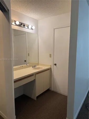 a spacious bathroom with a double vanity sink and mirror