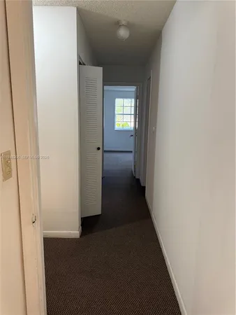 a view of a hallway with wooden shelves