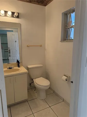a bathroom with a sink a toilet and mirror